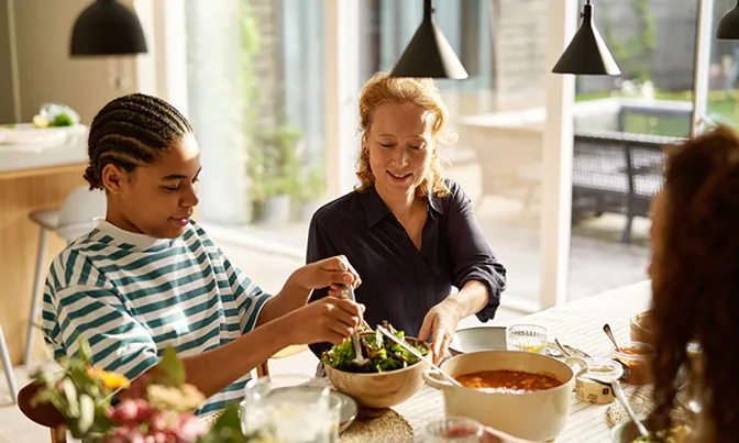 Family of three eating dinner together