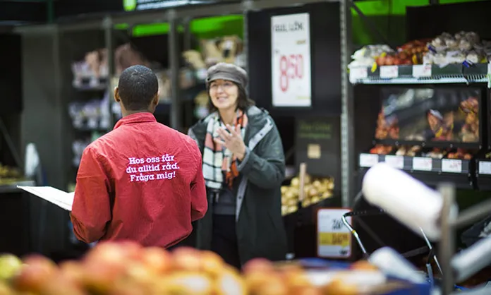 Employee and customer in store